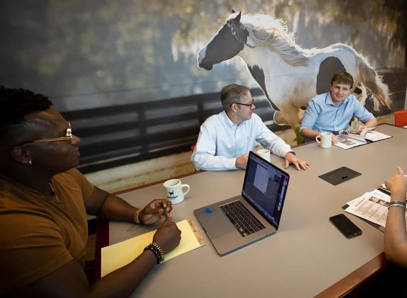 conference room for rent with chairs, desk, whiteboard, and tv