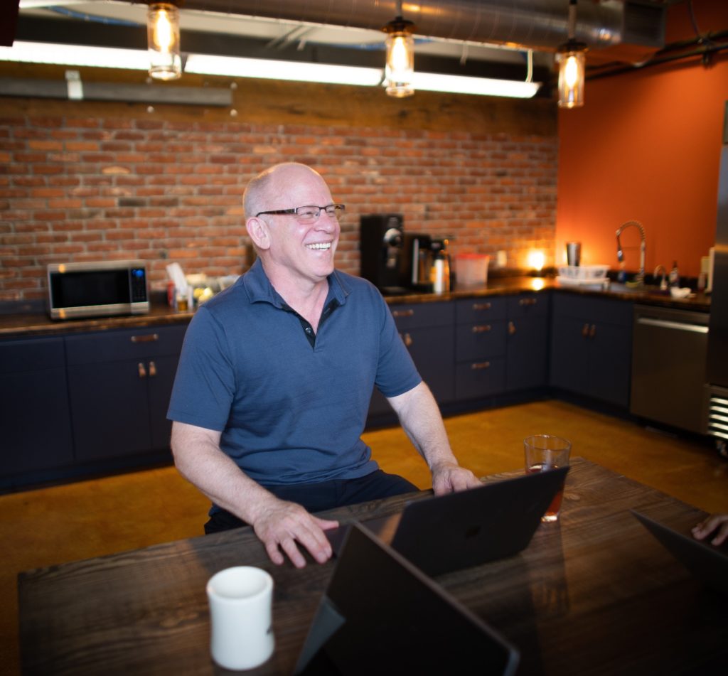 Man working at a desk in kitchen at Workhorse