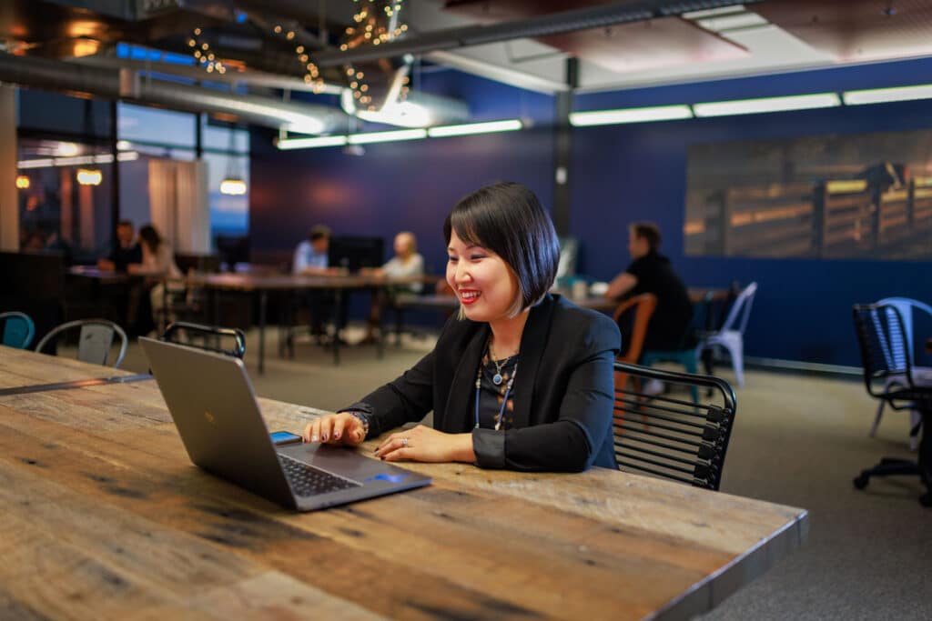 Woman working at a hot desk at Workhorse Coworking