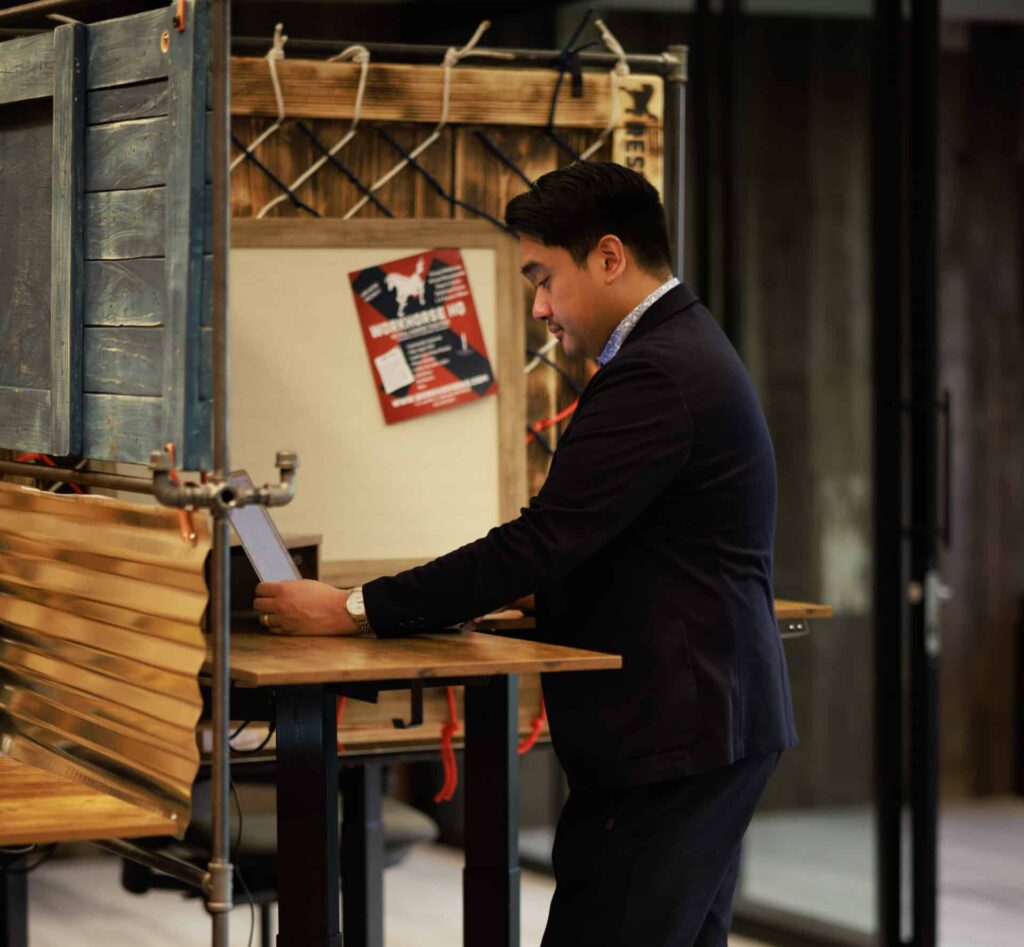 A man getting work done at his standing desk