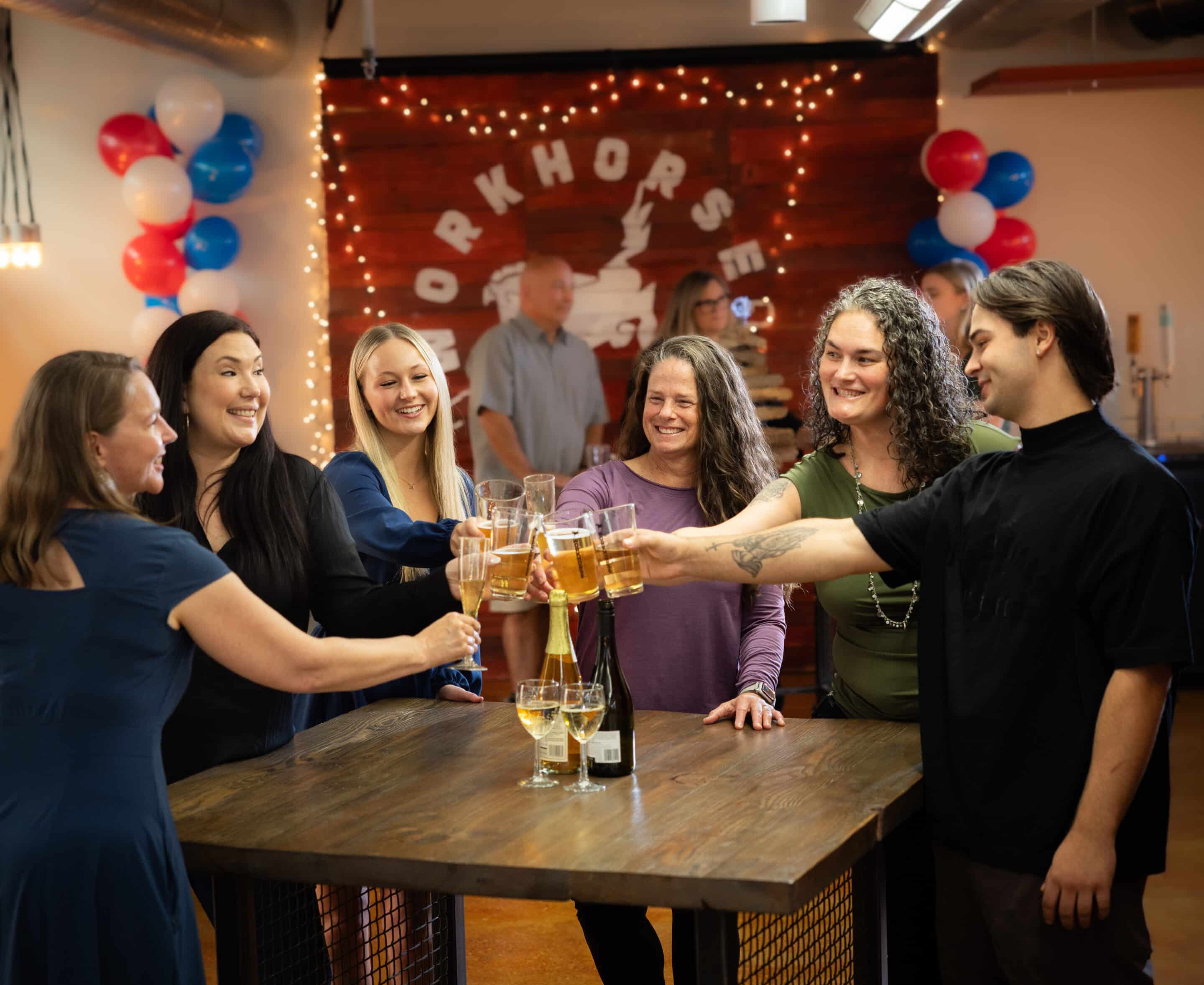 party of people toasting at rented event space in Edmonds at Workhorse Coworking