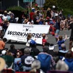 Edmonds 4th of July Parade with a street and huge crowds surrounding the floats walking in the parade.