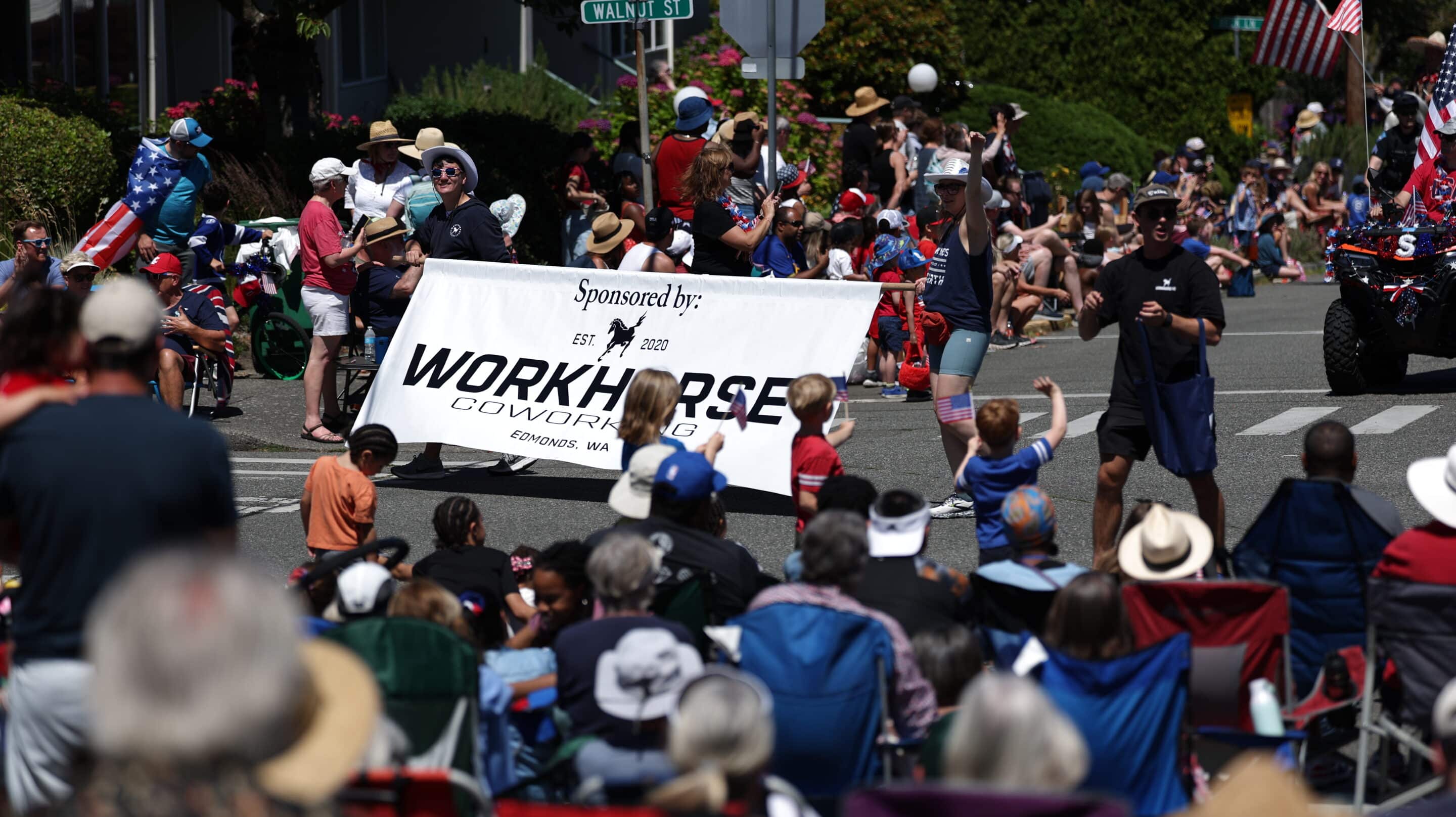 Edmonds 4th of July Parade with a street and huge crowds surrounding the floats walking in the parade.