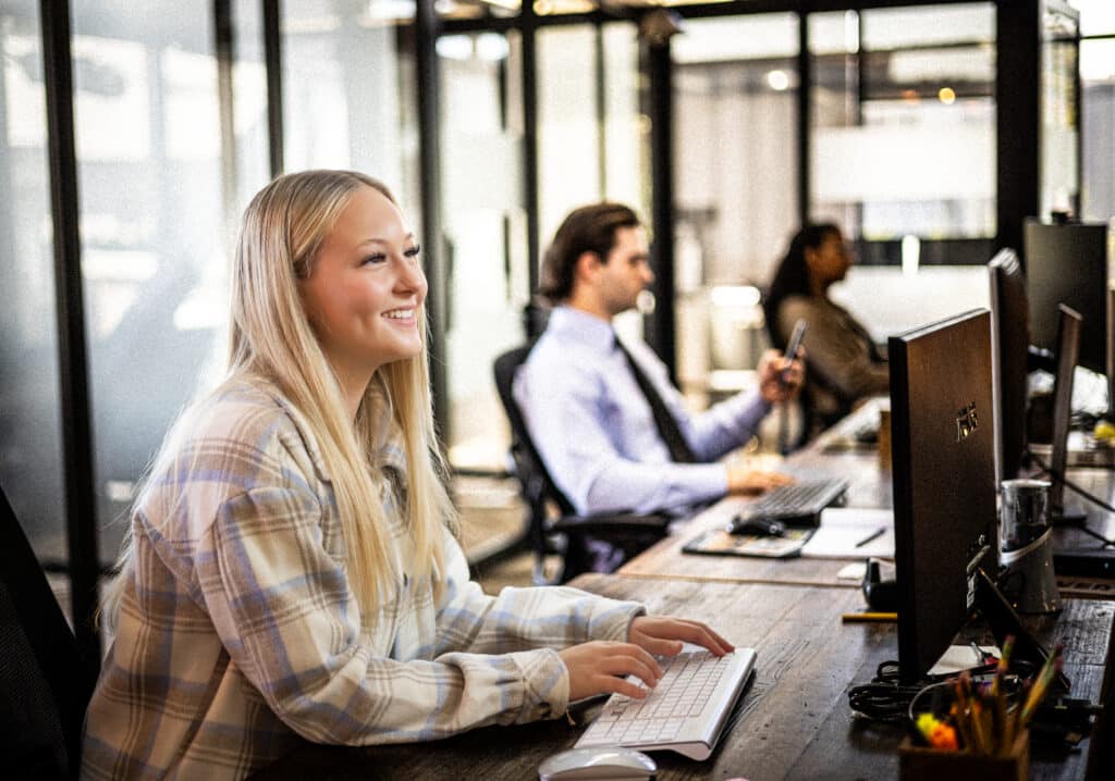 Woman smiling at dedicated desk in Edmonds, WA